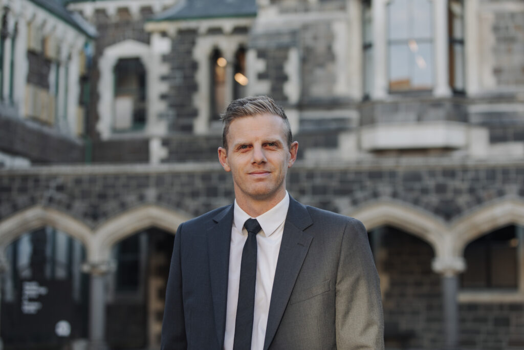 Man standing in front of stone building