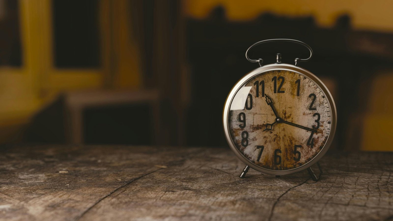 Alarm clock on an old wooden table